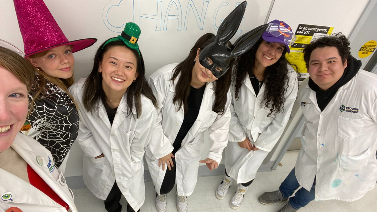 Woman looking at a sign spelling out "Science" in tiles