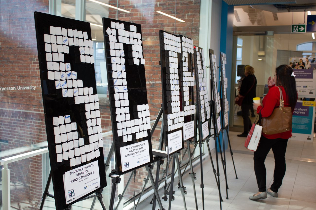 Woman looking at a sign spelling out "Science" in tiles